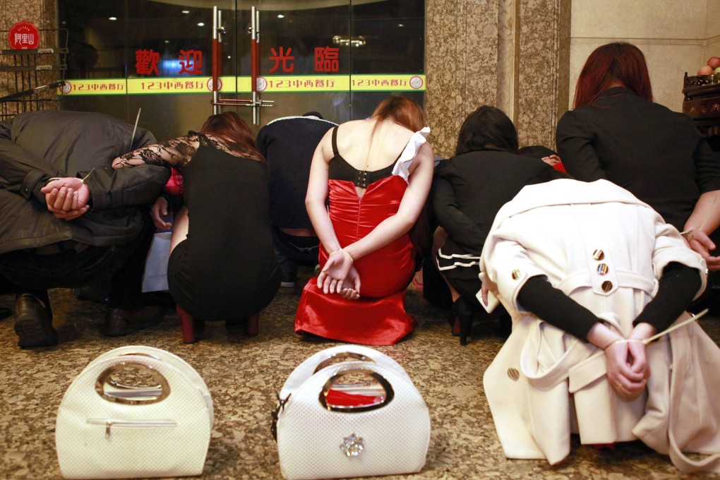 Police raid a suspected brothel in Dongguan. Photo: AFP