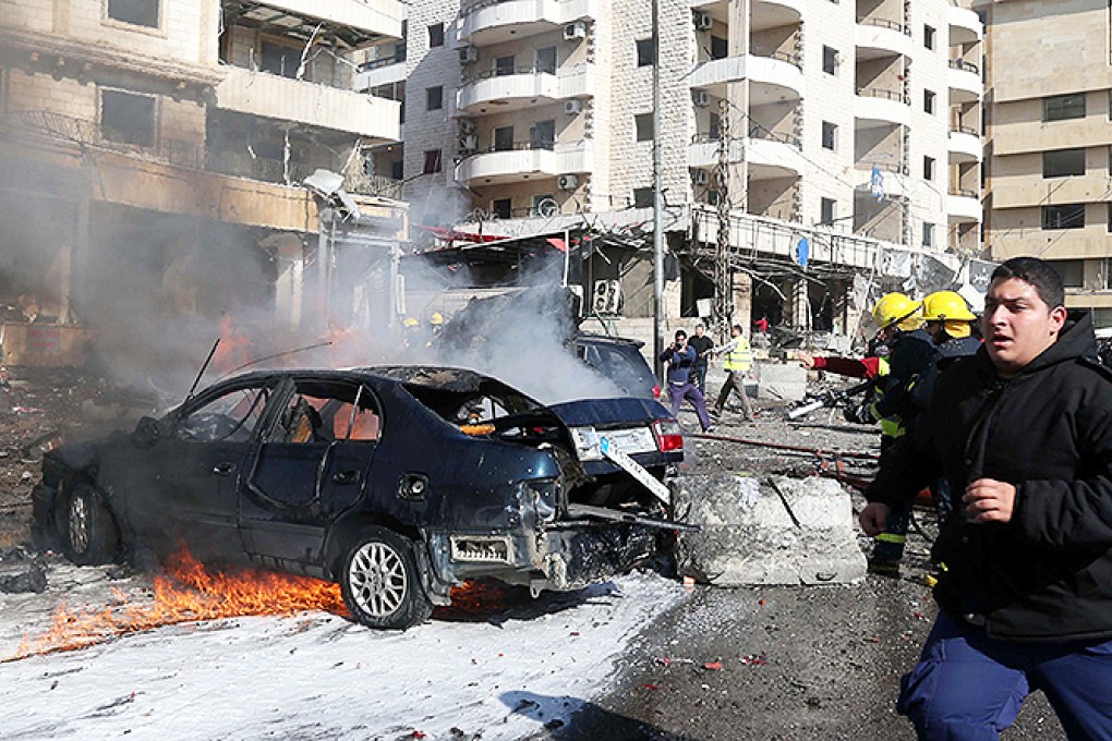 Emergency personnel work at the site of a bomb explosion in a southern suburb of Beirut. Photo: AFP