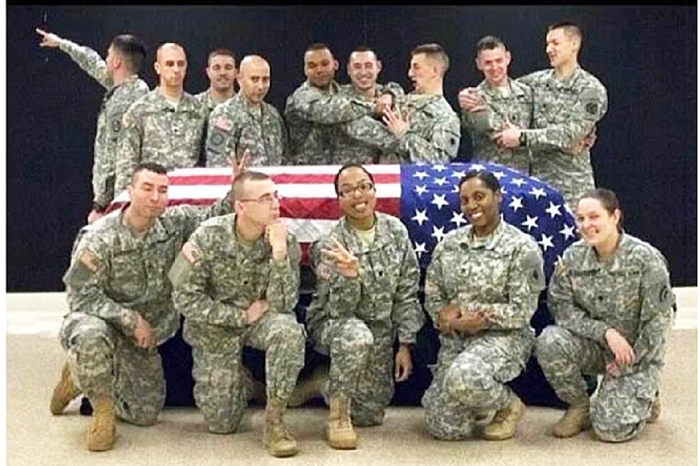 This photo posted to the instagram account belonging to Spc. Terry Harrison shows a dozen soldiers clowning around a casket draped in a flag at a National Guard training facility in Arkansas. Photo: AP