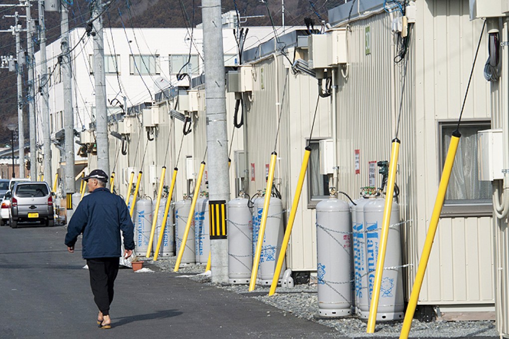 Almost three years after the tsunami, many people in Japan remain in temporary housing complexes. Photo: EPA