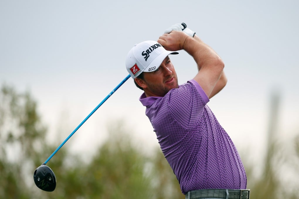 Graeme McDowell plays a shot against Gary Woodland. Photo: AFP