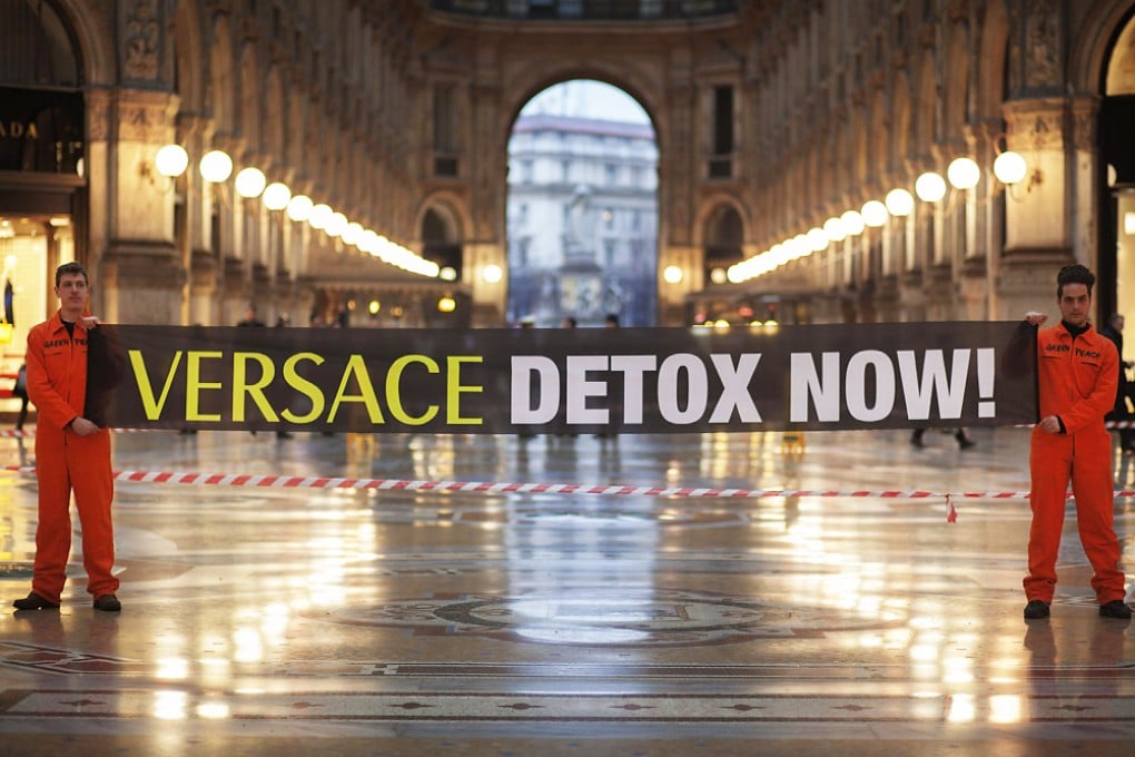 Greenpeace activists hold a banner reading "Versace detox now!" in the iconic Galleria Vittorio Emanuele heralding the start of Milan Fashion week in Milan. Photo: AFP