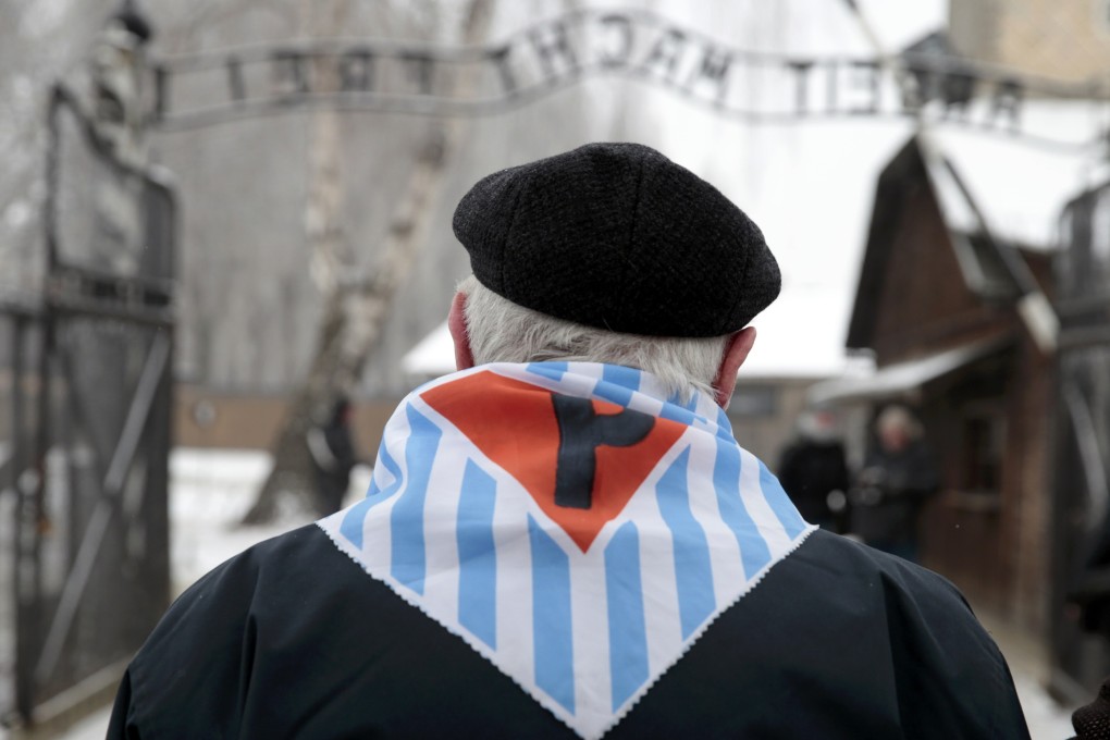 A Holocaust survivor stands in front of entrance of Auschwitz, the former Nazi concentration camp, on the 69th anniversary of its liberation in January this year. Photo: Reuters