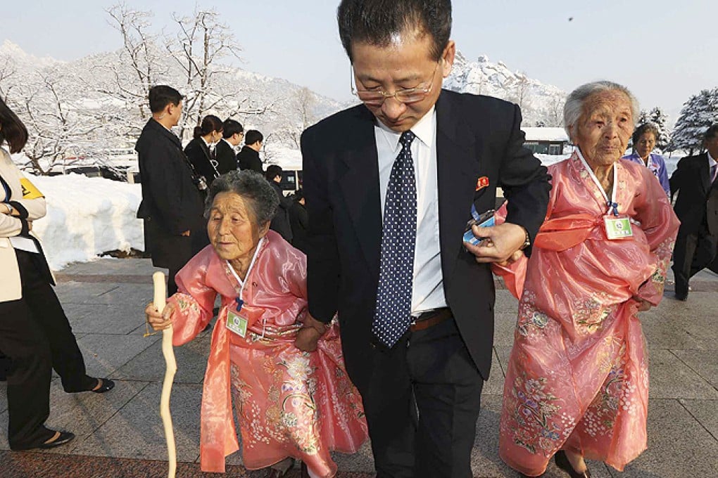 A North Korean man escorts his relatives to the Separated Family Reunion Meeting at Diamond Mountain resort in North Korea, on Friday. Photo: AP