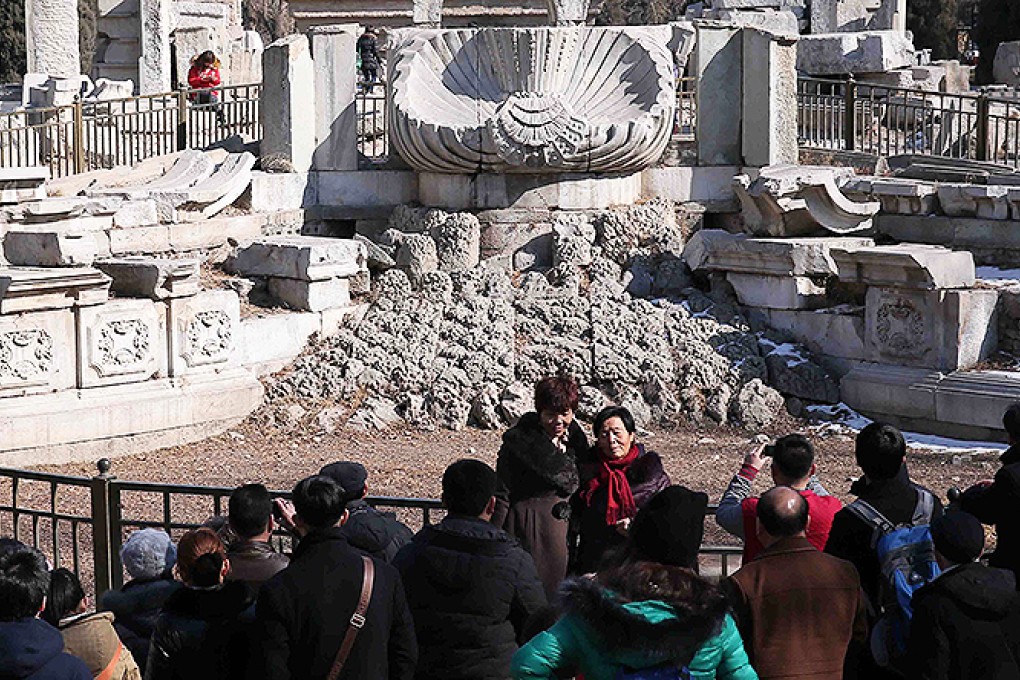 Visitors visit the relics of the Haiyantang Zodiac fountain at the Old Summer Palace in Beijing. Photo: AFP