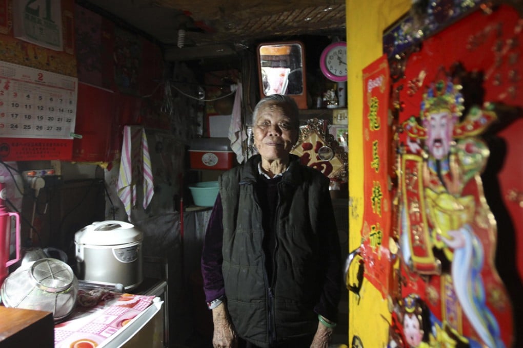 Lam Kam-sin in her home in one of the buildings on Castle Peak Road. Constructed in the 1950s, the blocks are to be replaced by 230 new flats. Photo: Felix Wong