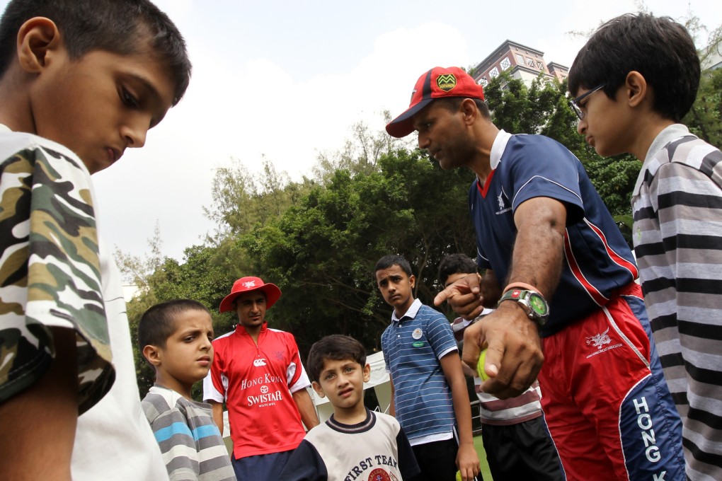 Left-arm spinner Najeeb Amar, pictured training children, is a welcome injection of talent for Hong Kong's tilt at the ICC World Twenty20. Photo: Edward Wong