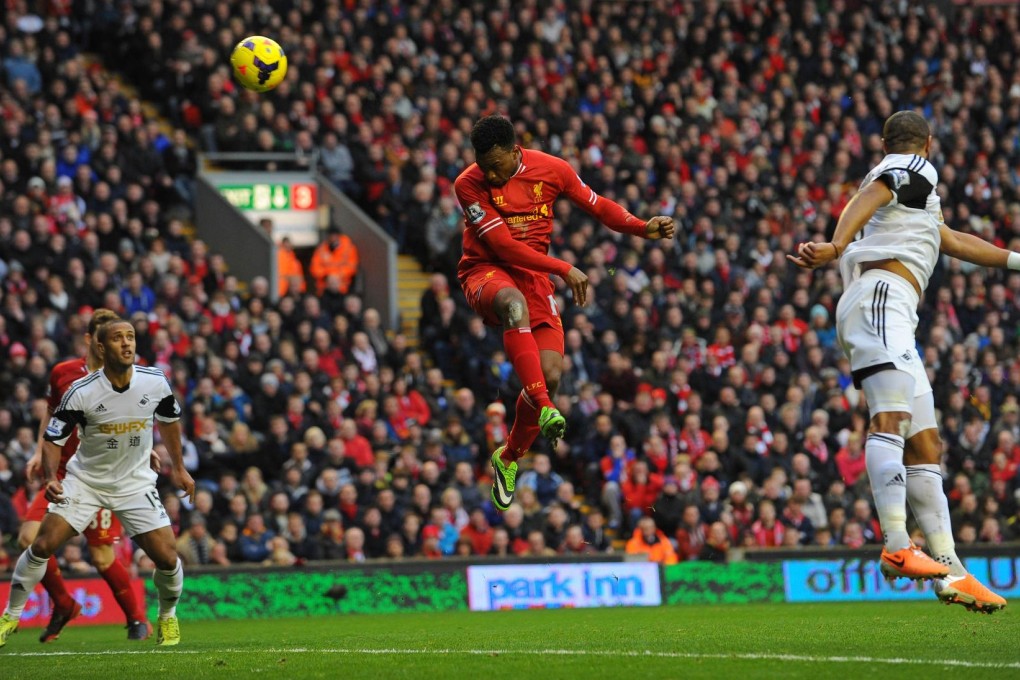 Liverpool's Daniel Sturridge scores his second goal with a header in their Premier League match with Swansea. Photo: AFP