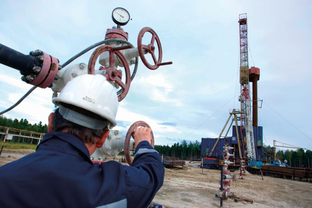 Yoho field crew turns on a master valve to a well.