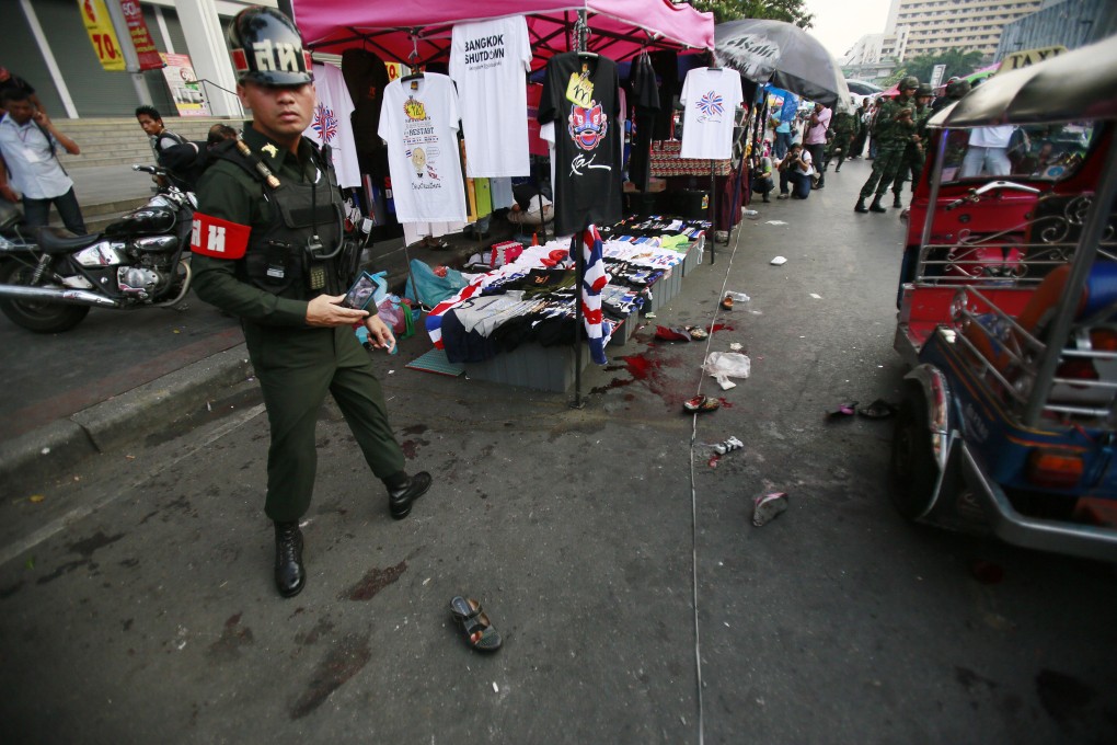 A military police officer stands at the scene of an explosion at a main protest site in Bangkok, which killed three including two children. Photo: AP