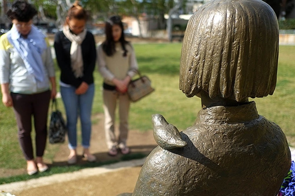 Korean women pay respects at the Glendale statue. Photo: AFP