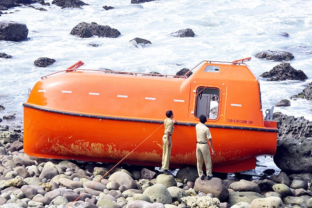 Indonesian officials check a lifeboat stranded on Karang Jambe beach, in Kebumen, Central Java province, Indonesia, on Tuesday. Photo: EPA