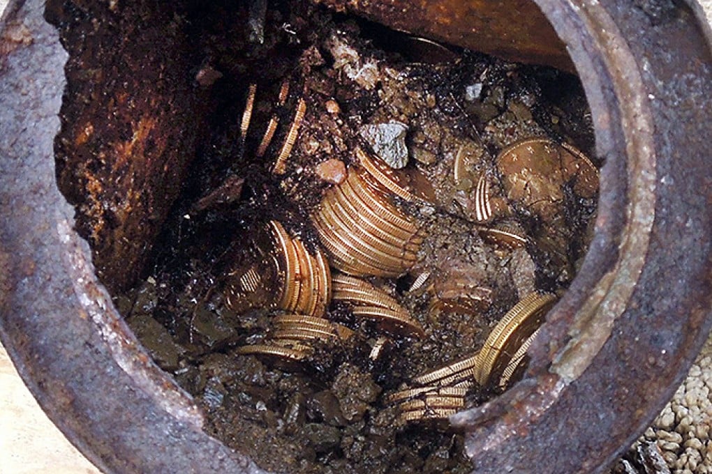 One of the six cans in which the coins were found. "Don't be above bending over to check on a rusty can," one of the finders said. Photo: AP