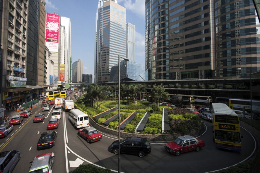 Morning traffic passes through the business district of Central in Hong Kong. Grade-A office rents in Central dropped 6.4 per cent last year. Photo: Bloomberg