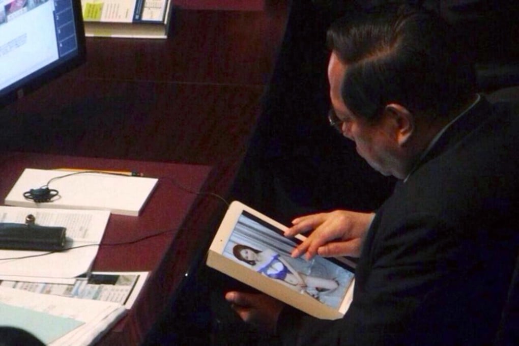 Lawmaker Albert Ho Chun-yan was caught browsing photos of models as the Financial Secretary John Tsang was giving his budget speech at the Legislative Council. Photo: SCMP Pictures