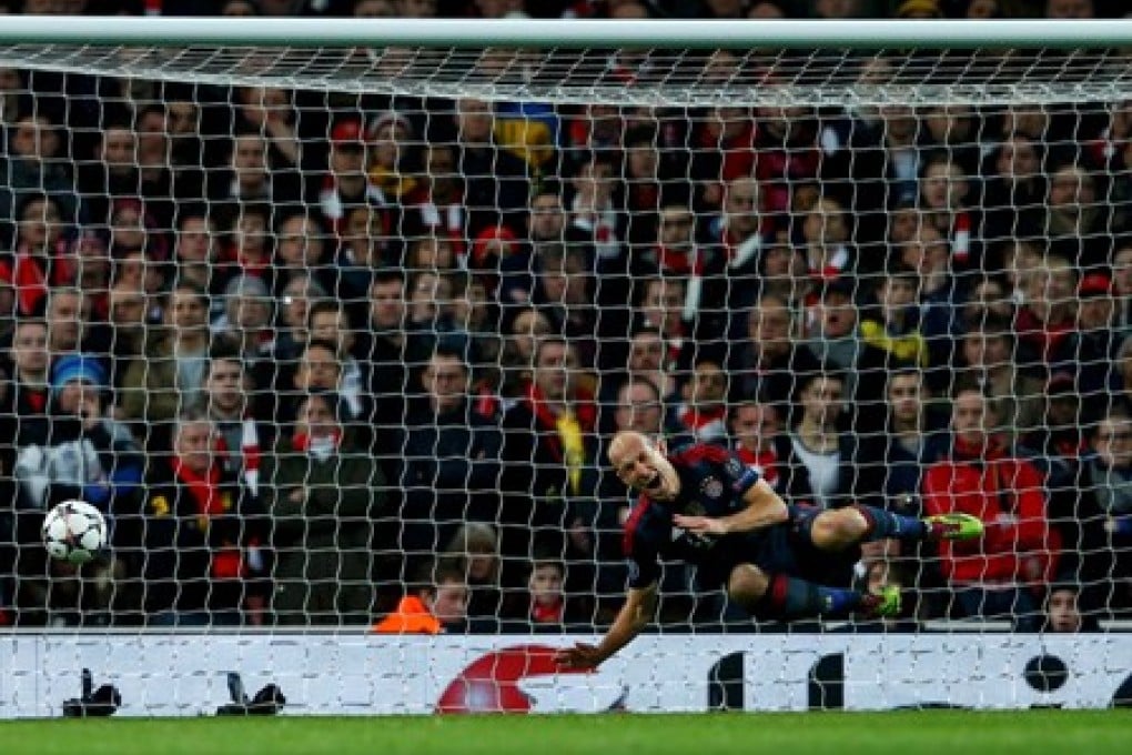 Bayern Munich's Arjen Robben reacts after a foul by Arsenal keeper Wojciech Szczesny (unseen) in their Champions League first leg match in the last 16 at the Emirates Stadium. Photo: Reuters