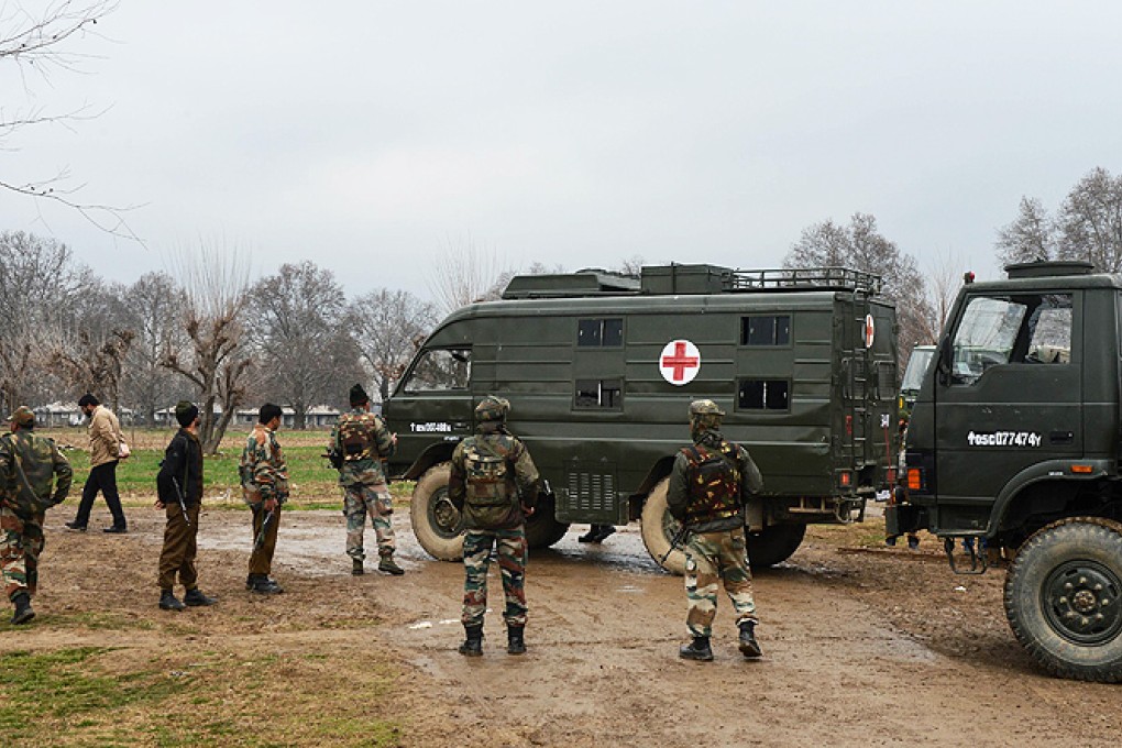 Indian army soldiers stand alongside an ambulance carrying the bodies of soldiers killed inside a army camp at Safapora some 20 kms from Srinagar on Thursday. Photo: AFP