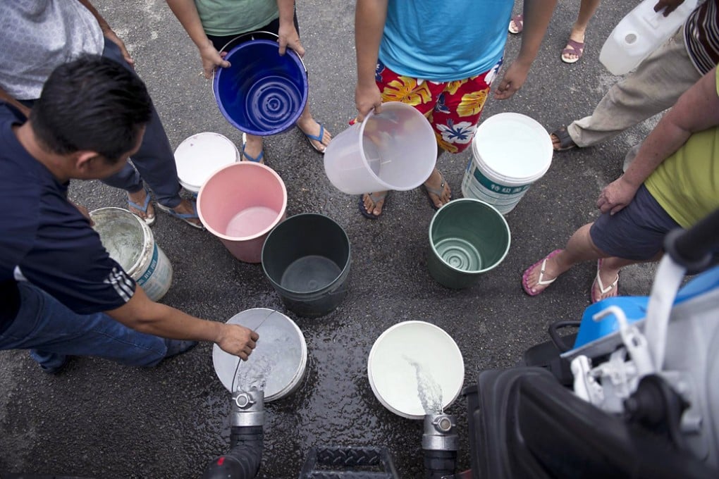 Residents collect water from a tanker truck in Balakong, outside the Malaysian capital, Kuala Lumpur. Photo: AFP