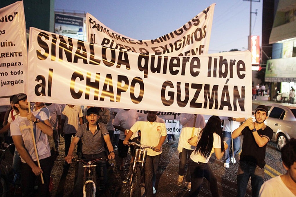 Protesters carry a sign reading, 'Sinaloa wants Chapo Guzman free' during a march in Culiacan on Wednesday. Photo: Reuters