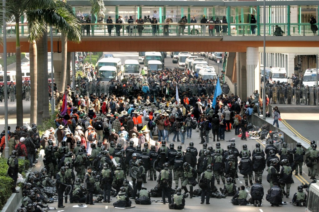 Police surround South Korean protestors in Hong Kong at the time of the WTO meeting in December 2005, which Tsang helped to organise. Tsang says this week's decision to relocate the Apec meeting from Hong Kong to Beijing was not motivated by concerns over the potential for similar scenes. Photo: AFP