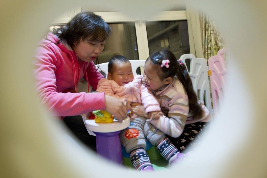 Stella Zhou, with her daughters Yunyun (left) and Zhuyi, worries over the effect of air pollution on her children and parents. Photo: Simon Song