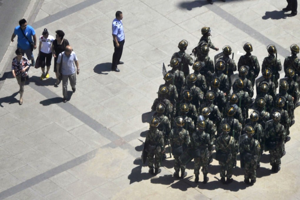 Armed police patrol in a square in Urumqi. Photo: AP