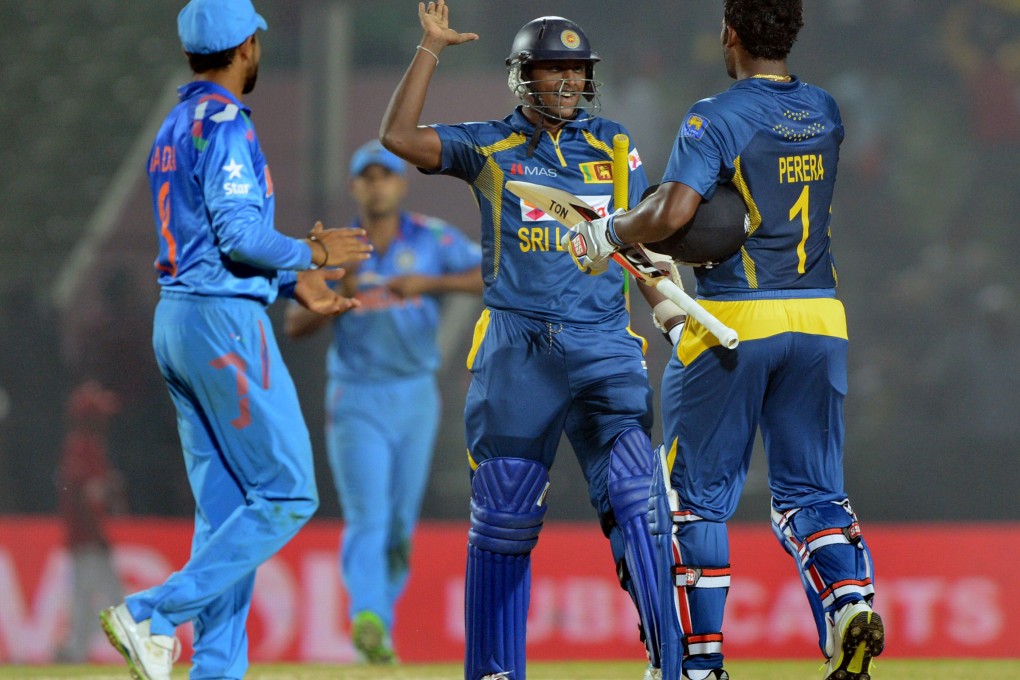 Sri Lankan batsman Ajantha Mendis (second right) celebrates with teammate Thisara Perera during the fourth match of the Asia Cup ODI tournament at the Khan Shaheb Osman Ali Stadium in Fatullah. Photo: AFP