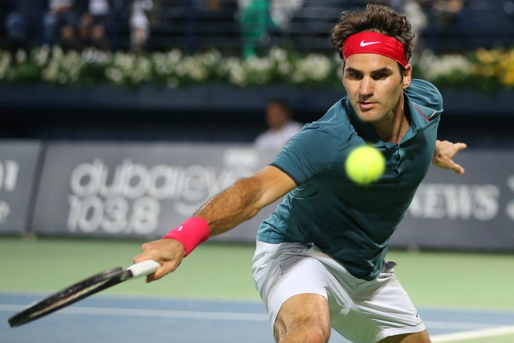 Roger Federer returns the ball to Tomas Berdych  during the Dubai Championships final. Photo: EPA