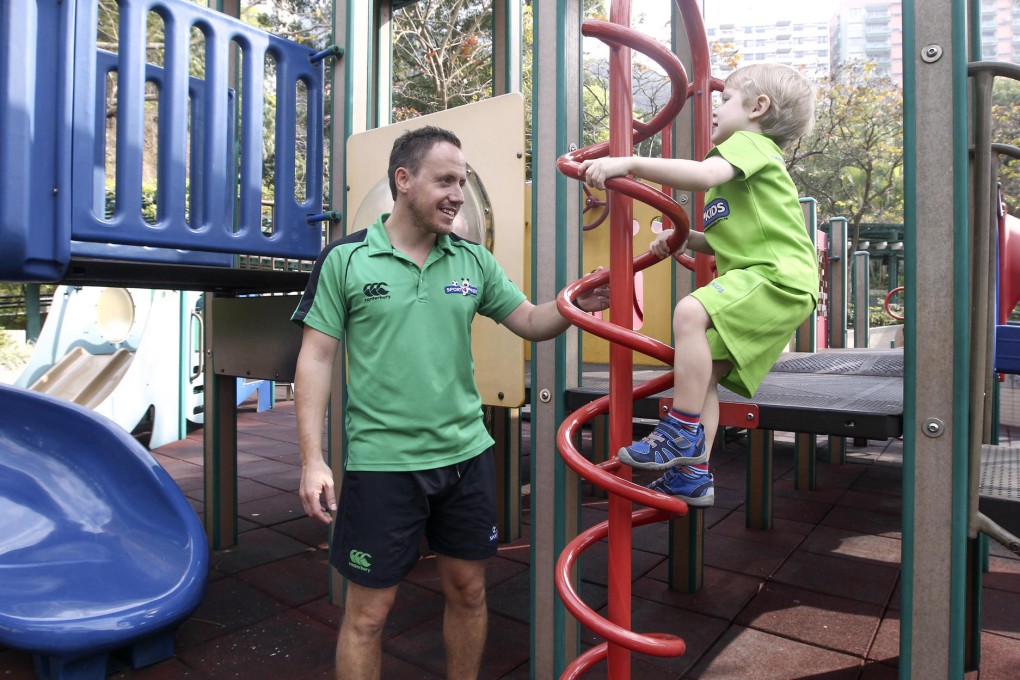 Sports coach Jimmy Quinlan and three-year-old Anthony Powell demonstrate ladder climb exercise. Photos: Jonathan Wong