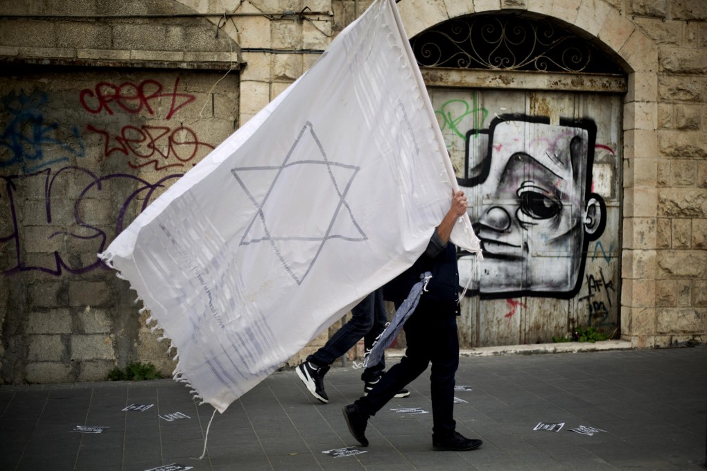 A man holds a prayer shawl during the rally in Jerusalem. Photo: AP