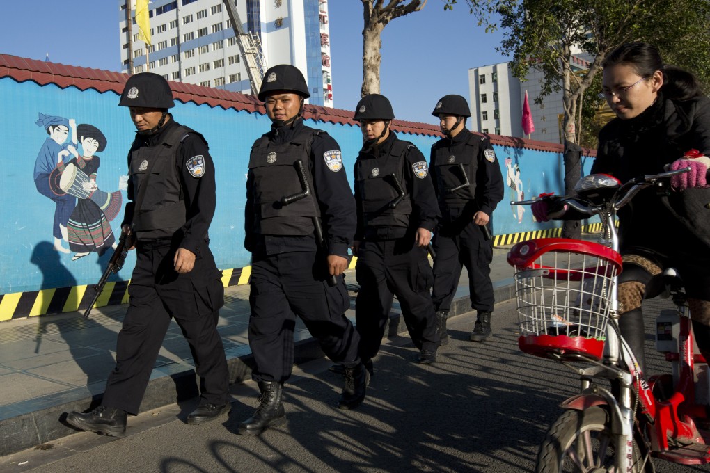 Armed policemen patrol on a street near the Kunming Railway Station on March 3, 2014. Photo: AP