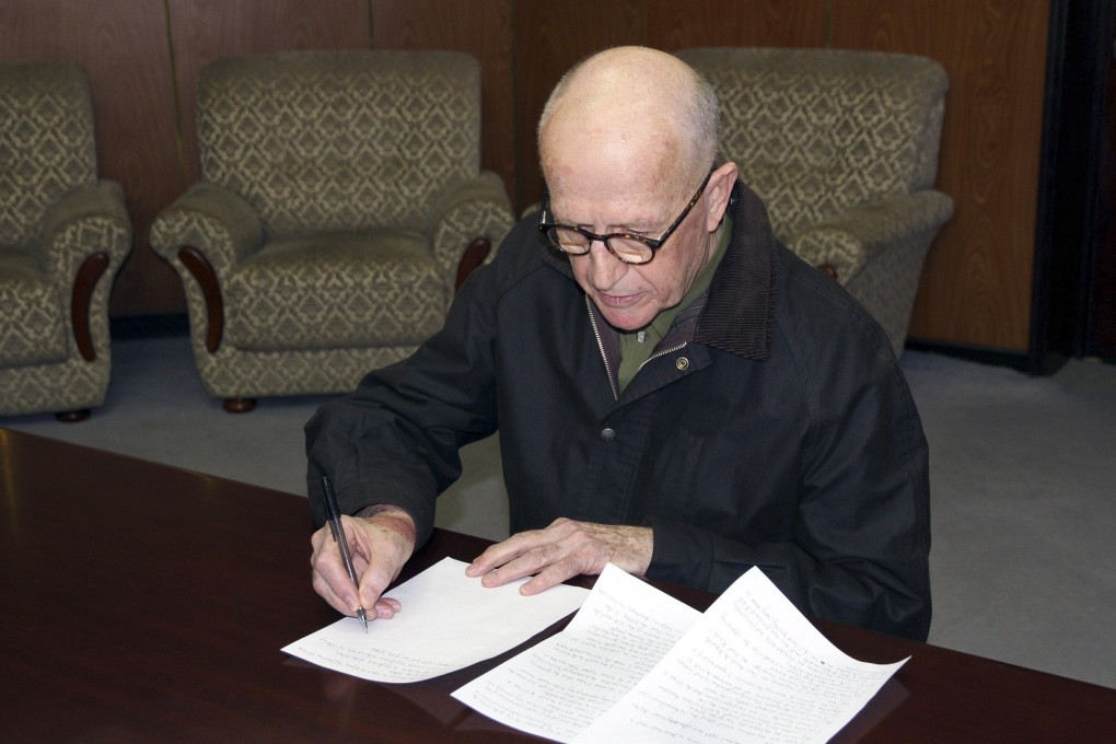 The state-run KCNA news agency released this photo of Short signing a written confession. Photo: KCNA / Reuters