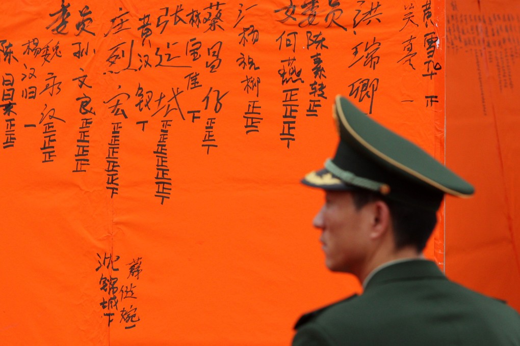A paramilitary policeman watches the vote canvassing during Wukan's landmark elections in 2012. Photo: Felix Wong