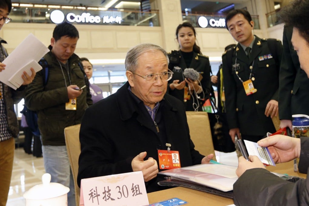 Yin Zhuo (centre) registers for the CPPCC conference in Beijing. Photo: Xinhua