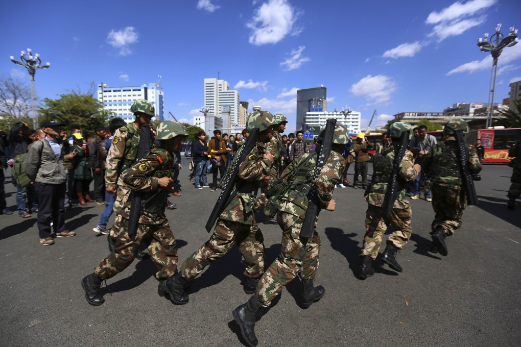 Paramilitary policemen patrol after a knife attack near Kunming railway station in Kunming. Photo: Reuters