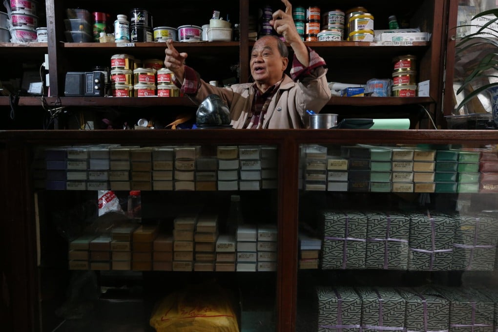 Tsui Pak-kim shows off his Nam Wah Company shop in Central, which will soon make way for redevelopment. Photo: David Wong