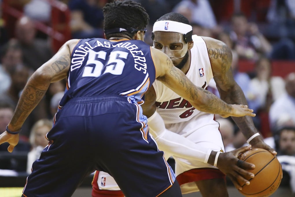 The Bobcats' Chris Douglas-Robert tries to block Miami Heat's LeBron James during Monday's encounter. Photo: AP
