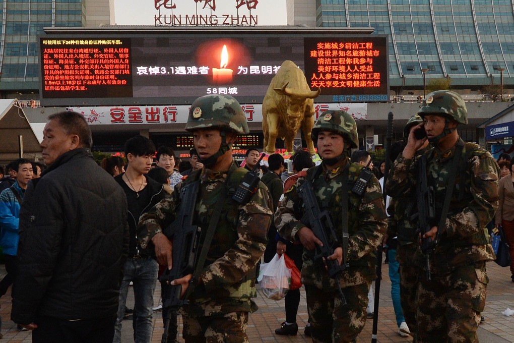 Chinese paramilitary police patrol outside the scene of the attack at the main train station in Kunming, Yunnan Province, on March 3, 2014. Photo: AFP