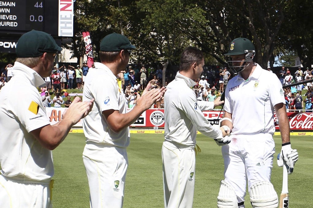 Australia's captain Michael Clarke shakes the hand of South African captain Graeme Smith as he comes out to bat for the last time during the fourth day of the third test at Newlands in Cape Town. Photo: Reuters