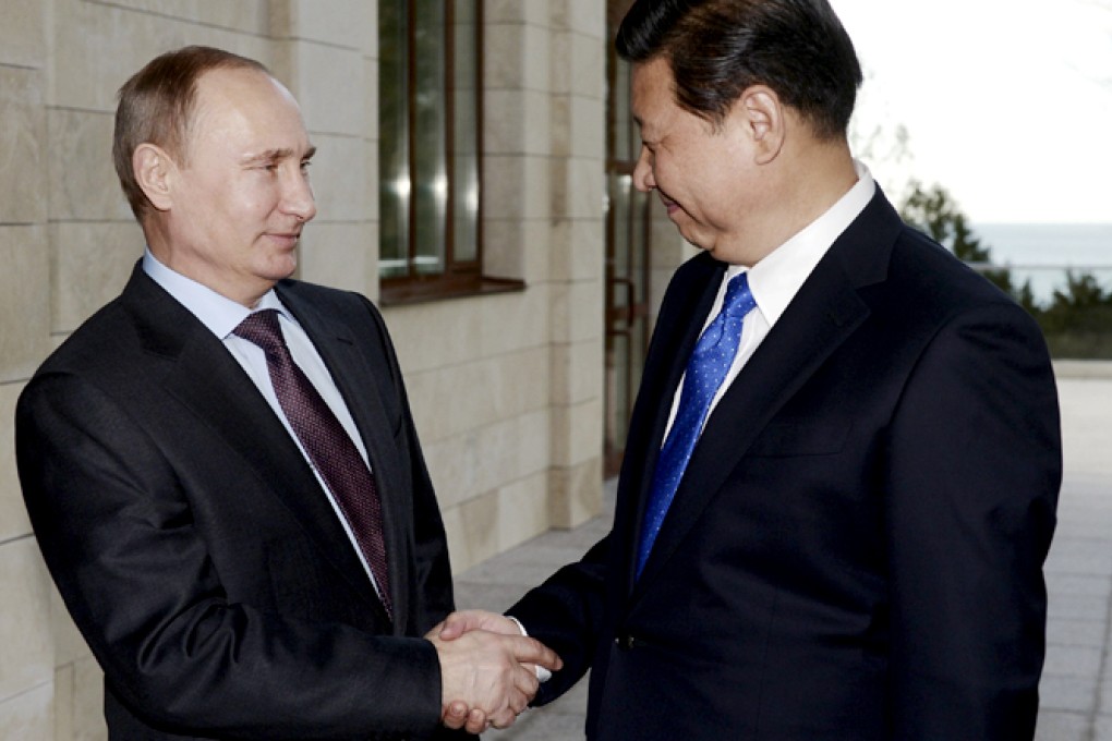 Russia's President Vladimir Putin (left) shakes hands with his Chinese counterpart Xi Jinping. Photo: Reuters