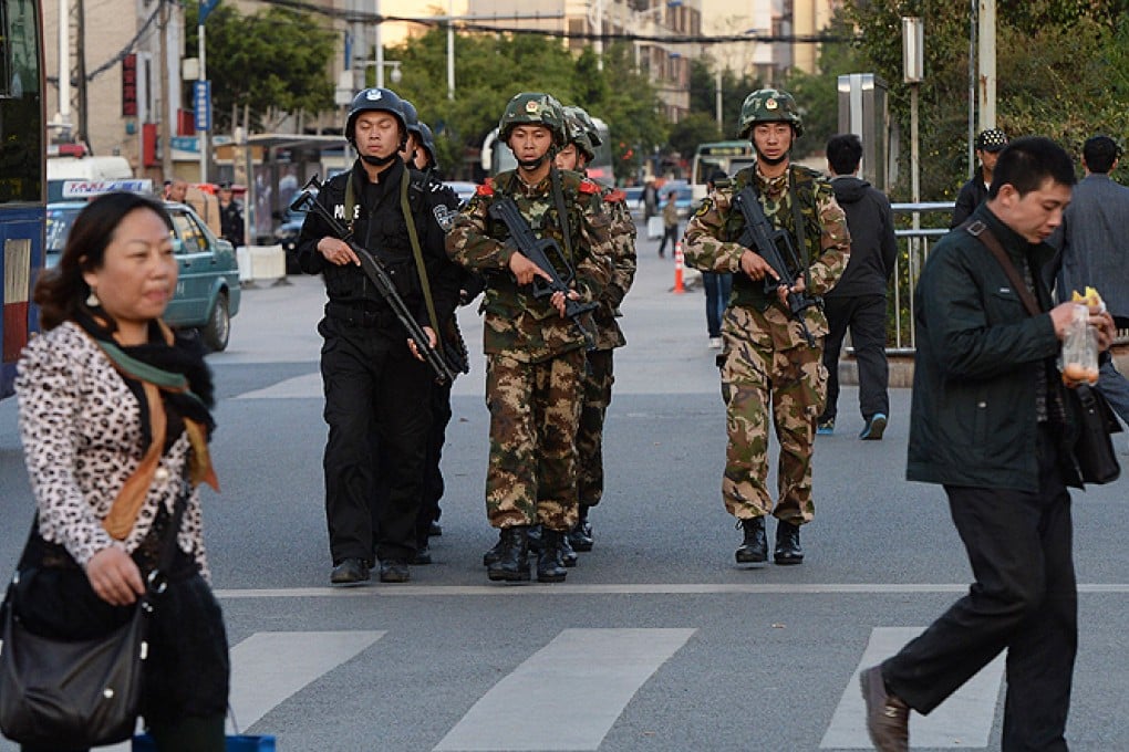 Chinese police and paramilitary soldiers patrol the streets after the attack at the main train station in Kunming, Yunnan province. Photo: AFP