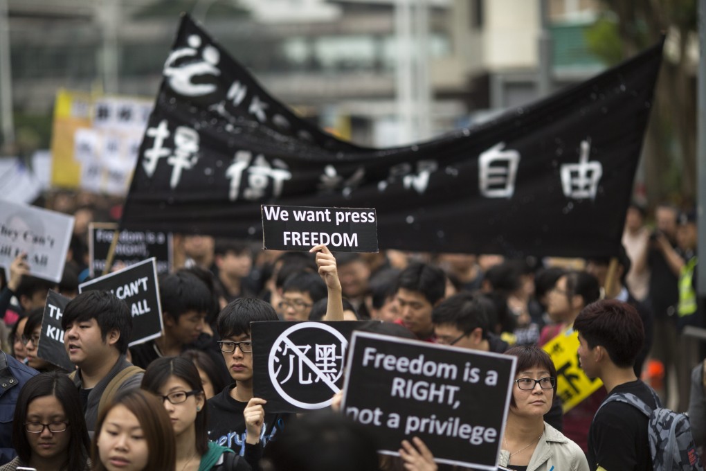Thousands of people took to the streets to protest the brutal chopping attack on former Ming Pao chief editor Kevin Lau Chun-to, and to rally support for press freedom. Photo: EPA