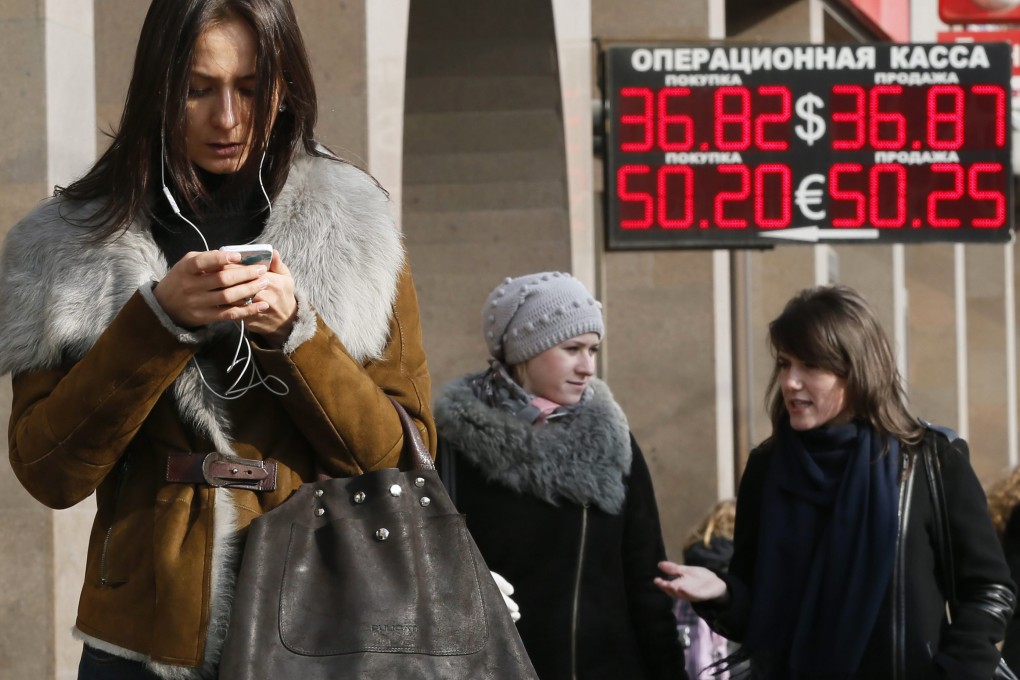 People walk past a currency exchange in Moscow, Russia. Photo: EPA