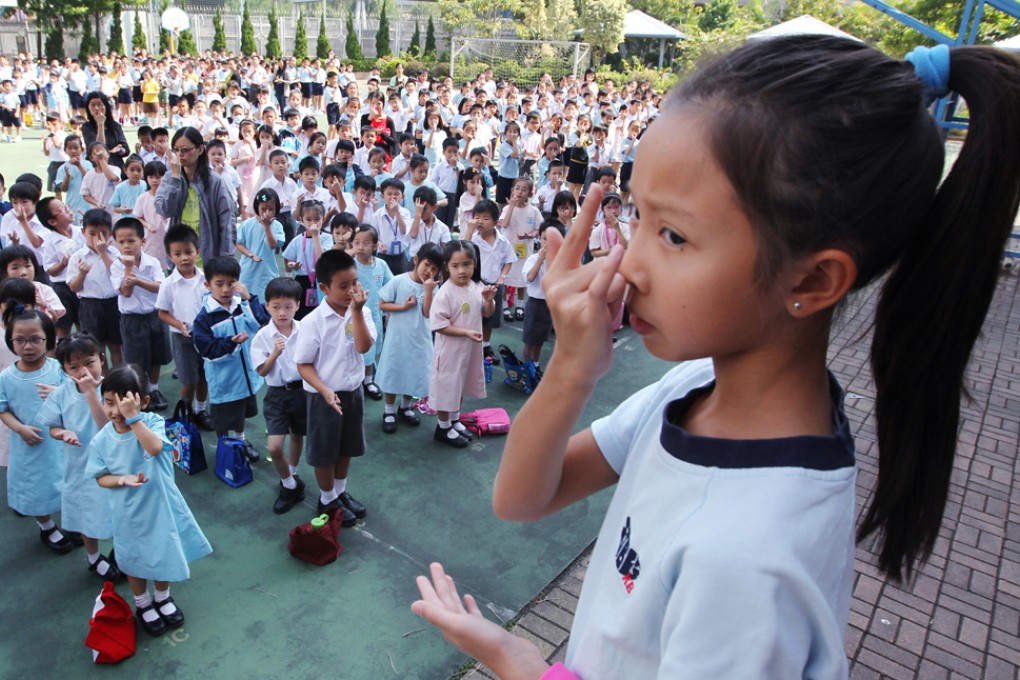A student leads a sign language learning session during recess at St. John The Baptist Catholic Primary School in Kowloon Bay. Photo: Nora Tam
