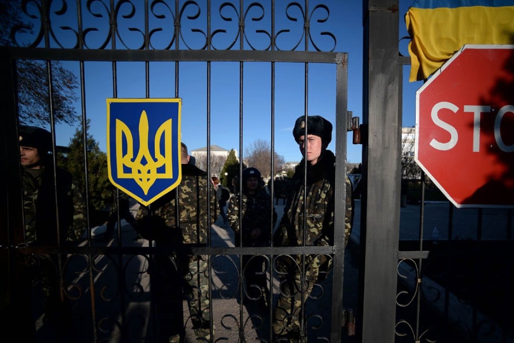 Ukrainian soldiers wait inside the Sevastopol tactical military brigade base. Russian forces have given Ukrainian soldiers an ultimatum to surrender their positions in Crimea or face an assault, a Ukrainian defence ministry spokesman said. Photo: AFP