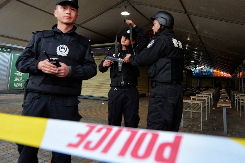 Police secure the crime scene after the railway attack in Kunming on March 1. Among the aims of China's sizable domestic security budget is to fund surveillance against dissidents  to prevent such attacks. Photo: AFP