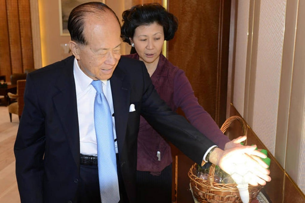 Li Ka-shing and Solina Chau Hoi-shuen, director of the Li Ka-shing Foundation, in Li's Cheung Kong Center office. Caixin photo by Du Jiang