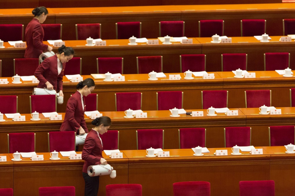 Attendants pour water for tea at the opening session of the National Peoples Congress at the Great Hall of the People in Beijing. Photo: EPA