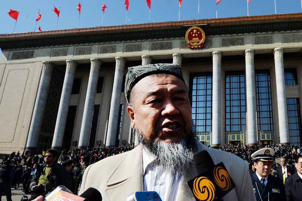 A Chinese Uygur delegate from Xinjiang province is questioned by reporters about issues relating to the terrorist attack in Kunming on Wednesday. Photo: AFP