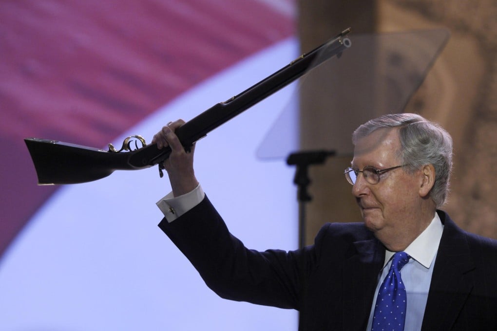 Senator Mitch McConnell holds up the flintlock rifle.Photo: AP